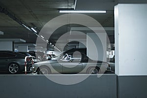 Vintage sports car on parking lot in garage.