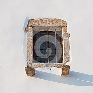 A vintage square window in a cycladic style house in Greece