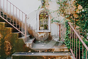 Vintage stair with window on white wall