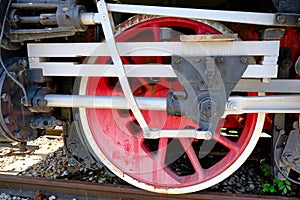 Vintage steam locomotive detail with cranks and red wheels