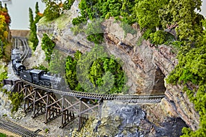 Vintage Steam Locomotive on Model Trestle Bridge with Scenic Diorama