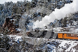 Vintage Steam Train Billowing Smoke as it Moves Through the Mountains