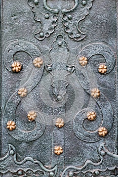 Vintage steel door decorated with wrought iron, pattern fragment of door to the cathedral in Lviv