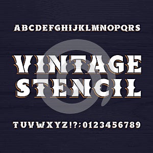 Vintage stencil typeface. Retro alphabet font on a wooden background.