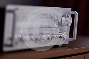 Vintage Stereo Receiver Standing on the Wooden Sideboard, Side View Closeup