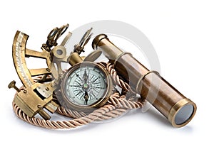 Vintage still life with compass,sextant and spyglass on white background