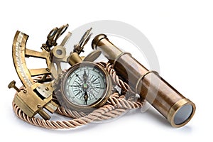 Vintage still life with compass,sextant and spyglass on white background photo