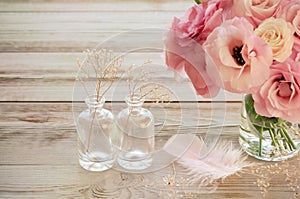 Vintage Still life with Eustoma flowers in a vase with fearher photo