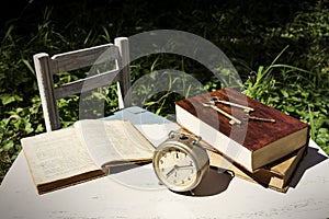 Vintage still life with old alarm clock, keys and books