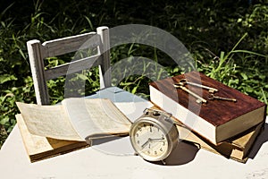 Vintage still life with old alarm clock, keys and books