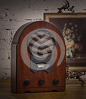 Vintage still life of an old analogue wooden radio and golden fr