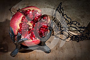 Vintage still life with pomegranate and mask