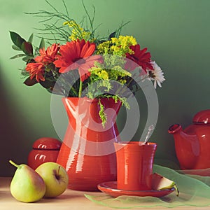 Vintage still life with red tableware, flowers and fruits