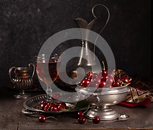 Vintage still life with ripe cherry and pewter