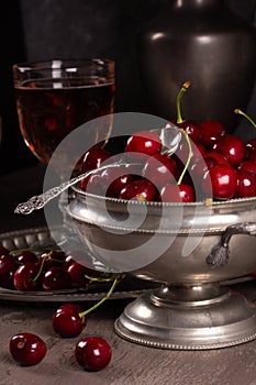 Vintage still life with ripe cherry and pewter