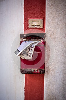 Vintage Italian Charm: Old White Wall with Red Stripe, Red Mailbox, and Mail Sticking Out in Typical Polignano a Mare Street
