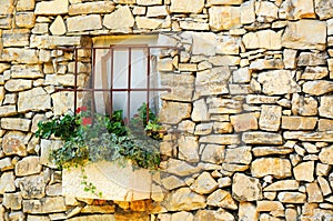 Vintage stone wall with little window