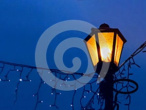 Vintage street lamp on a night background with a blur effect. Closeup.