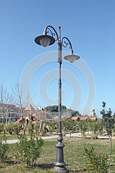 Vintage street light.black street lamp in an open blue sky . Street lantern on background blue sky . Old street light.