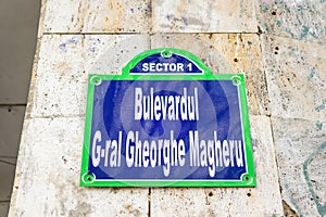 Vintage street sign showing Bulevardul General Gheorghe Magheru (Gheorghe Magheru Boulevard) displayed on an street in