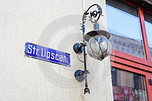 Vintage street sign showing Strada Lipscani (Lipscani Street) displayed on an street in the old city center of Bucharest