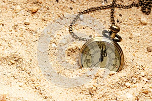 Vintage style clock in the sand