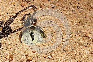 Vintage style clock in the sand