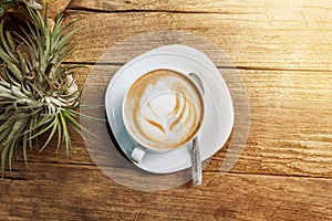 Vintage style cup of hot coffee on wood table