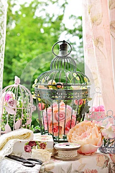 Vintage style decoration with sewing stuffs and bird cages photo