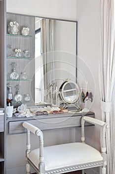 Vintage style dressing room with classic white chair and dressing table