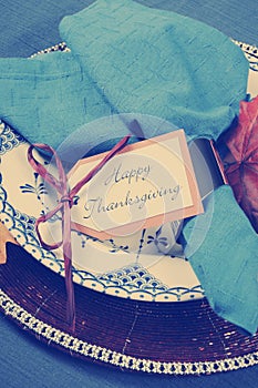 Vintage style Happy Thanksgiving dining table place setting with retro filter - closeup.