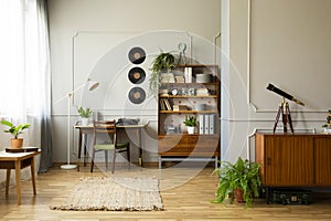 Vintage style home office with desk with typewriter and bookshelf next to it, real photo photo