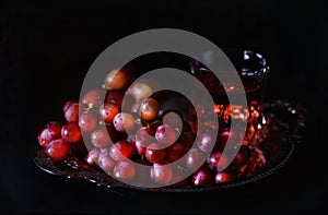 Vintage style image of red grapes in a silver antique tray