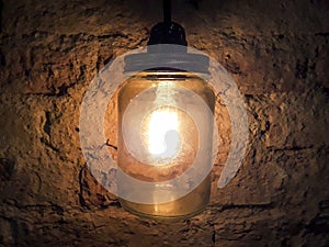Vintage style lamp at rustic wall