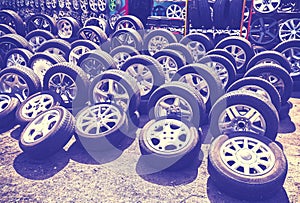 Vintage style picture of car wheels and aluminum rims.