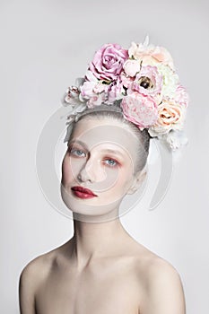 Vintage style portrait of beautiful girl with fancy flower hairdo