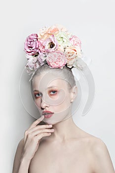 Vintage style portrait of beautiful girl with fancy flower hairdo