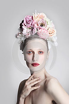 Vintage style portrait of beautiful girl with fancy flower hairdo