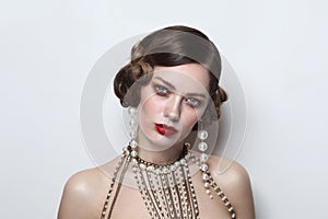 Vintage style portrait of beautiful woman with fancy pearl earrings and necklace