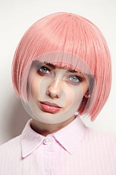 Vintage style portrait of beautiful woman in fancy pink wig