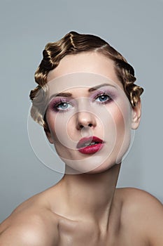 Vintage style portrait of beautiful woman with fancy prom hairdo