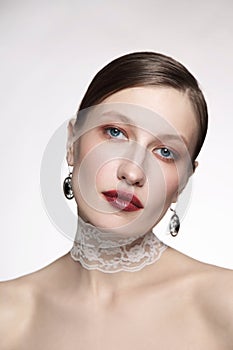 Vintage style portrait of young woman with fancy makeup and lace chocker