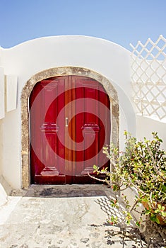 Vintage style red front door. Vastu Shastra main entrance energy flow concept.