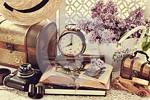 Vintage style still life with old photographs and camera in sepia