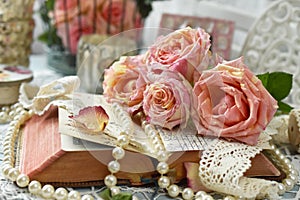 Vintage style still life with roses and old book