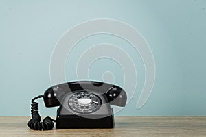 Vintage Styled Rotary Phone on wooden table.  3d illustration