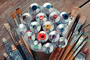 Vintage stylized photo of oil multicolor paint tubes closeup photo