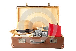 Vintage suitcase and beach accessories isolated on white background