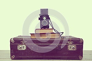 Vintage suitcase with books and camera