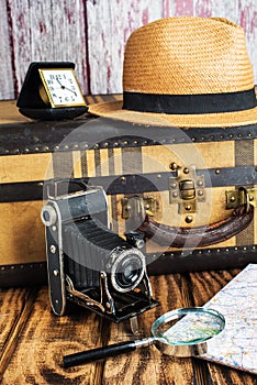 Vintage suitcase, map, magnifier and old camera